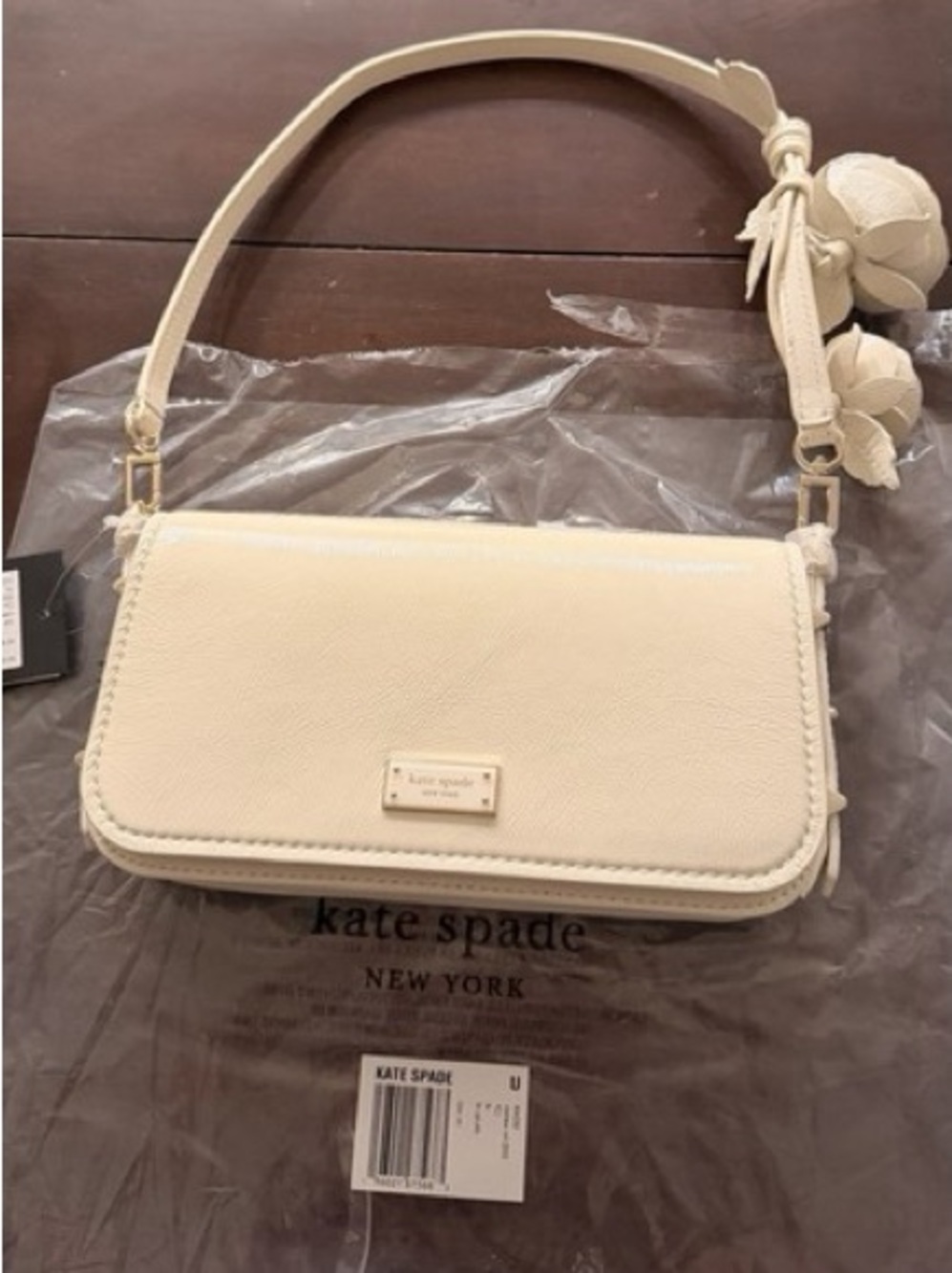 kate spade cream leather shoulder bag with floral pom charm